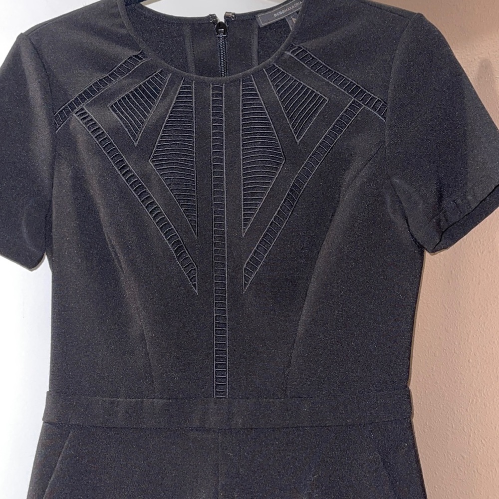 Black romper with cutout chest design.